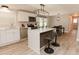 Modern kitchen boasts white cabinets, stainless steel appliances, and a stylish island with bar seating at 6914 N Baggett Rd, Douglasville, GA 30134