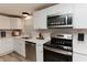 Updated kitchen with white cabinetry, stainless steel appliances, quartz countertops and modern fixtures at 6914 N Baggett Rd, Douglasville, GA 30134