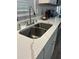 Kitchen sink featuring stainless steel fixtures, quartz countertop, and white cabinets at 6914 N Baggett Rd, Douglasville, GA 30134