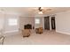 Spacious living room with a fireplace, barn door, and neutral carpet at 6914 N Baggett Rd, Douglasville, GA 30134