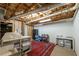 Partially finished basement with exposed ceiling, carpeting, storage units, and workbench at 1590 Greyson Rdg, Marietta, GA 30062