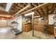 Unfinished basement with exposed ceiling, concrete flooring, and workbench at 1590 Greyson Rdg, Marietta, GA 30062