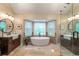 Bright bathroom with a freestanding tub, double vanities, and glass-enclosed shower, providing a spa-like experience at 1590 Greyson Rdg, Marietta, GA 30062