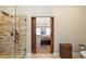 Bathroom showcasing the glass shower and bedroom entrance, offering modern convenience and a stylish design at 1590 Greyson Rdg, Marietta, GA 30062