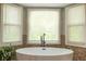 Bright bathroom showcasing a modern tub with a window view, creating a serene and relaxing atmosphere at 1590 Greyson Rdg, Marietta, GA 30062