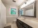 Bright bathroom with a modern vanity, white countertops, and decorative mirror at 1590 Greyson Rdg, Marietta, GA 30062