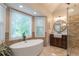 Elegant bathroom with a modern tub, stylish fixtures, and a glass shower, creating a luxurious and relaxing space at 1590 Greyson Rdg, Marietta, GA 30062
