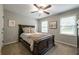 This charming bedroom features natural lighting, a ceiling fan, and carpeted floors at 1590 Greyson Rdg, Marietta, GA 30062