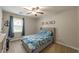 Comfortable bedroom with a window, blue curtains, and gray furnishings at 1590 Greyson Rdg, Marietta, GA 30062