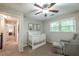 Comfortable Bedroom with a crib, chair, neutral colors, and natural light at 1590 Greyson Rdg, Marietta, GA 30062