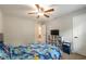 Comfortable bedroom with a ceiling fan, a window, and gray furnishings at 1590 Greyson Rdg, Marietta, GA 30062