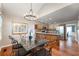 Dining room with hardwood floors, chandelier, and glass table next to the kitchen at 1590 Greyson Rdg, Marietta, GA 30062