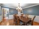 Formal dining room with hardwood flooring, chandelier lighting, and classic blue wall color at 1590 Greyson Rdg, Marietta, GA 30062