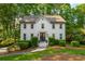 Charming two-story home with a landscaped front yard and classic white brick facade at 1590 Greyson Rdg, Marietta, GA 30062