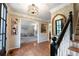 Bright entryway with hardwood flooring, decorative lighting, and an open view to the playroom at 1590 Greyson Rdg, Marietta, GA 30062