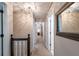 Hallway featuring modern lighting, neutral tones, and access to various rooms, creating a seamless flow throughout the home at 1590 Greyson Rdg, Marietta, GA 30062