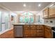 Well-lit kitchen with granite countertops, stainless steel appliances, and a view to the pantry at 1590 Greyson Rdg, Marietta, GA 30062