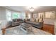 Spacious living room features hardwood floors, comfortable sofas, and large windows at 1590 Greyson Rdg, Marietta, GA 30062