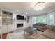 Cozy living room with fireplace, built-in bookshelves, and large windows overlooking the yard at 1590 Greyson Rdg, Marietta, GA 30062