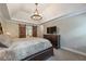 Comfortable main bedroom featuring a tray ceiling, a stylish dresser, and barn doors connecting to the bathroom, offering convenience at 1590 Greyson Rdg, Marietta, GA 30062