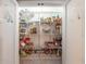 Walk-in pantry features white shelving and decorative etched doors for organized storage in the kitchen at 1590 Greyson Rdg, Marietta, GA 30062