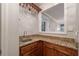 Charming wet bar featuring wood cabinetry, granite countertop and glassware rack, perfect for entertaining guests at 1590 Greyson Rdg, Marietta, GA 30062
