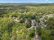Picture perfect aerial view of neighborhood surrounded by mature trees and lush green landscape at 165 Colony Cir, Canton, GA 30114