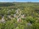 An aerial view of a neighborhood surrounded by lush trees and greenery in a serene area at 165 Colony Cir, Canton, GA 30114