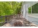 Relax on this home's spacious back deck with outdoor seating and wooded view at 165 Colony Cir, Canton, GA 30114
