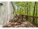 Exterior view of a wooden back deck with table and chairs with wooded view at 165 Colony Cir, Canton, GA 30114