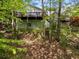 Back of the house with a view of the backyard and wooded area at 165 Colony Cir, Canton, GA 30114