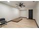 Finished basement area with wood floors, black trim, and modern ceiling fan fixture at 165 Colony Cir, Canton, GA 30114