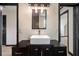 This elegant bathroom includes a modern vessel sink, custom vanity, and decorative lighting at 165 Colony Cir, Canton, GA 30114