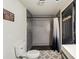 Bathroom with decorative tile flooring, tiled shower, and black painted door at 165 Colony Cir, Canton, GA 30114