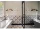 This luxurious bathroom includes a freestanding tub, glass enclosed shower, and unique patterned tile at 165 Colony Cir, Canton, GA 30114