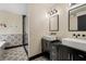 This bathroom includes double sinks, elegant fixtures, and custom tile work in the shower at 165 Colony Cir, Canton, GA 30114
