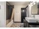 This stylish bathroom includes a modern vessel sink, tub/shower, and attractive floor tiles at 165 Colony Cir, Canton, GA 30114