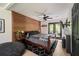 This bedroom features a wood accent wall, ceiling fan, and access to a private balcony at 165 Colony Cir, Canton, GA 30114