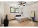 Bedroom boasts wood flooring and a ceiling fan with natural light from the windows at 165 Colony Cir, Canton, GA 30114