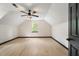 Bright bedroom features wood flooring, a ceiling fan, and a window with natural light at 165 Colony Cir, Canton, GA 30114