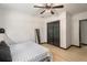 Cozy bedroom features wood flooring, a ceiling fan, and a mirrored closet at 165 Colony Cir, Canton, GA 30114