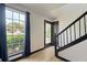 Entryway with black framed door, staircase and view of the front yard through a window at 165 Colony Cir, Canton, GA 30114