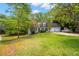 Charming single-Gathering home featuring dormer windows, a well-manicured lawn, and an attached two-car garage at 165 Colony Cir, Canton, GA 30114