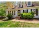 Well-maintained home with dormer windows, black shutters, and mature landscaping enhancing its curb appeal at 165 Colony Cir, Canton, GA 30114