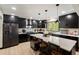Bright kitchen features black cabinets, granite countertops, and stainless steel appliances at 165 Colony Cir, Canton, GA 30114