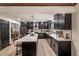 Gourmet kitchen with an island, granite countertops, black cabinets and views to the dining room at 165 Colony Cir, Canton, GA 30114