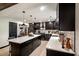 Spacious kitchen features granite countertops, black cabinets, and a large island with seating at 165 Colony Cir, Canton, GA 30114