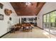 Living room with a wooden ceiling, wood accents, open to the modern kitchen and outdoor views at 165 Colony Cir, Canton, GA 30114