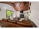 Living room with a wood ceiling, a fireplace, and sliding glass doors to the backyard at 165 Colony Cir, Canton, GA 30114