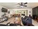 Bright and open living room with hardwood flooring, ceiling fan and a view of the kitchen and dining area at 165 Colony Cir, Canton, GA 30114